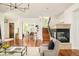 Cozy living room featuring a fireplace, hardwood floors, and staircase to the next level at 2990 Osceola St, Denver, CO 80212