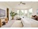Bright main bedroom featuring a ceiling fan, large windows, and a cozy sitting area at 2990 Osceola St, Denver, CO 80212