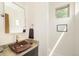 Modern powder room with custom sink, stylish mirror, and natural light from a window at 2990 Osceola St, Denver, CO 80212