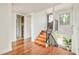 Open staircase featuring hardwood floors, modern railing, and an abundance of natural light throughout the entry at 2990 Osceola St, Denver, CO 80212