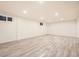 A large basement with laminate flooring and recessed lighting at 10751 W 66Th Ave, Arvada, CO 80004