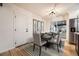 Elegant dining room with light fixture and sliding glass doors to backyard at 10751 W 66Th Ave, Arvada, CO 80004