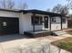 Charming exterior featuring freshly painted white brick and black trim at 10751 W 66Th Ave, Arvada, CO 80004