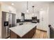 Modern kitchen featuring white cabinets, subway tile backsplash, and large island at 10751 W 66Th Ave, Arvada, CO 80004