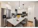 Modern kitchen featuring white cabinets, subway tile backsplash, and large island at 10751 W 66Th Ave, Arvada, CO 80004