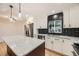 This kitchen includes stainless steel appliances, black subway tile backsplash, and white cabinetry at 10751 W 66Th Ave, Arvada, CO 80004