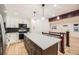 A kitchen with a spacious island, stainless steel appliances, and lots of natural light at 10751 W 66Th Ave, Arvada, CO 80004