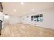 Open-concept living room features refinished hardwood floors and neutral paint for a bright feel at 10751 W 66Th Ave, Arvada, CO 80004