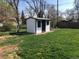 Exterior view of the black and white shed surrounded by green grass at 10751 W 66Th Ave, Arvada, CO 80004