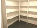 A walk-in storage room showcasing custom white shelving and gray epoxy floors at 10751 W 66Th Ave, Arvada, CO 80004