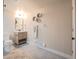 Well-lit bathroom features a classic vanity, toilet, and decorative wall art and fresh towels at 3957 S Peach Way, Denver, CO 80237