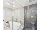 Sleek bathroom featuring a glass-enclosed shower and soaking tub accented with gold hardware at 3957 S Peach Way, Denver, CO 80237