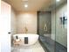 Elegant bathroom with a freestanding tub, sleek glass-enclosed shower, and high-end gold fixtures at 3957 S Peach Way, Denver, CO 80237