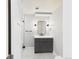 Bathroom featuring a modern vanity, lighting and door to shower at 3957 S Peach Way, Denver, CO 80237