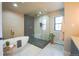 Elegant bathroom with a freestanding tub, sleek glass-enclosed shower, and high-end gold fixtures at 3957 S Peach Way, Denver, CO 80237