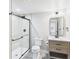 Modern bathroom featuring stone floors, glass shower with black trim, neutral vanity, and a toilet at 3957 S Peach Way, Denver, CO 80237