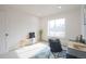 Bright bedroom features large window, neutral walls, and stylish decor, creating a serene and inviting atmosphere at 3957 S Peach Way, Denver, CO 80237
