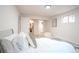 Well-lit bedroom features the bed and decor, with access to other rooms like a bathroom at 3957 S Peach Way, Denver, CO 80237