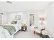 Bedroom with neutral carpet, a bed, lamps, and access to an ensuite bathroom at 3957 S Peach Way, Denver, CO 80237