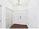 Bright entryway with white double doors, closet and modern light fixture at 3957 S Peach Way, Denver, CO 80237