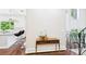 Bright entryway with hardwood floors, adjacent to the staircase and kitchen at 3957 S Peach Way, Denver, CO 80237