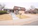 Charming brick home with a unique roof, tidy front yard, and attached two car garage at 3957 S Peach Way, Denver, CO 80237