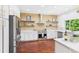 Modern kitchen featuring stainless steel appliances, white cabinets and hardwood floors at 3957 S Peach Way, Denver, CO 80237