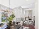 Open-concept living area with hardwood floors and modern lighting at 3957 S Peach Way, Denver, CO 80237