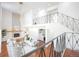 Modern living room with fireplace, hardwood floors, and wrought iron staircase at 3957 S Peach Way, Denver, CO 80237