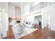 Bright living room with high ceilings, fireplace, wet bar, and modern furnishings at 3957 S Peach Way, Denver, CO 80237
