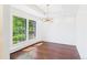 Sun-filled living room featuring hardwood floors and bright windows at 3957 S Peach Way, Denver, CO 80237