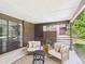 Covered patio with brick detailing, outdoor furniture, and greenery providing a serene retreat at 3957 S Peach Way, Denver, CO 80237