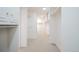 Large walk-in closet with bright lighting, carpeted floors, and ample shelving and drawers at 3957 S Peach Way, Denver, CO 80237