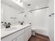 Modern bathroom showcasing double sinks, white cabinets, and dark bronze fixtures with wood-look floors at 24748 E 40Th Ave, Aurora, CO 80019
