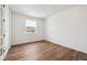 Bright bedroom with a large window, wood flooring, and neutral walls, ready for personalization at 24748 E 40Th Ave, Aurora, CO 80019