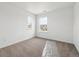 Bright, carpeted bedroom featuring two windows offering neighborhood views, perfect for a cozy retreat at 24748 E 40Th Ave, Aurora, CO 80019