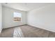 Bright bedroom features a large window with a neighborhood view and neutral-toned carpet at 24748 E 40Th Ave, Aurora, CO 80019