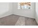 Bright carpeted bedroom featuring one window offering neighborhood views, perfect for a cozy retreat at 24748 E 40Th Ave, Aurora, CO 80019