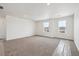 Large bedroom featuring plush carpet, two bright windows, and neutral walls, offering serene living space at 24748 E 40Th Ave, Aurora, CO 80019