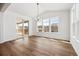 Bright dining area with vaulted ceiling, wood floors, large windows, and sliding glass doors to deck at 24748 E 40Th Ave, Aurora, CO 80019