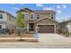 Charming two-story home with stone accents, a two-car garage, and a well-manicured lawn at 24748 E 40Th Ave, Aurora, CO 80019