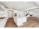 Open kitchen featuring white cabinets, a center island with seating, and stainless steel appliances at 24748 E 40Th Ave, Aurora, CO 80019