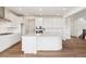 Modern kitchen with white cabinets, center island and sleek fixtures offering a bright and airy feel at 24748 E 40Th Ave, Aurora, CO 80019