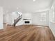 Open-concept living room with a staircase, fireplace, and wood floors, perfect for entertaining at 24748 E 40Th Ave, Aurora, CO 80019