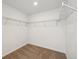 Spacious walk-in closet featuring carpeted flooring and wire shelving for ample storage in this home at 24748 E 40Th Ave, Aurora, CO 80019