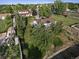 Aerial view of the home shows a large, fenced yard with mature trees and landscaping at 874 Mercury Cir, Lone Tree, CO 80124