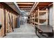 Unfinished basement with exposed beams, shelving, and mechanicals provides storage and utility space at 874 Mercury Cir, Lone Tree, CO 80124
