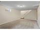 Unfinished basement featuring neutral carpet and access to stairs and an egress window at 874 Mercury Cir, Lone Tree, CO 80124