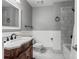 Traditional bathroom with marble countertop, designer fixtures, tiled floors, and a tiled shower at 874 Mercury Cir, Lone Tree, CO 80124