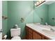 Well-lit bathroom with a white sink and vanity paired with green walls at 874 Mercury Cir, Lone Tree, CO 80124
